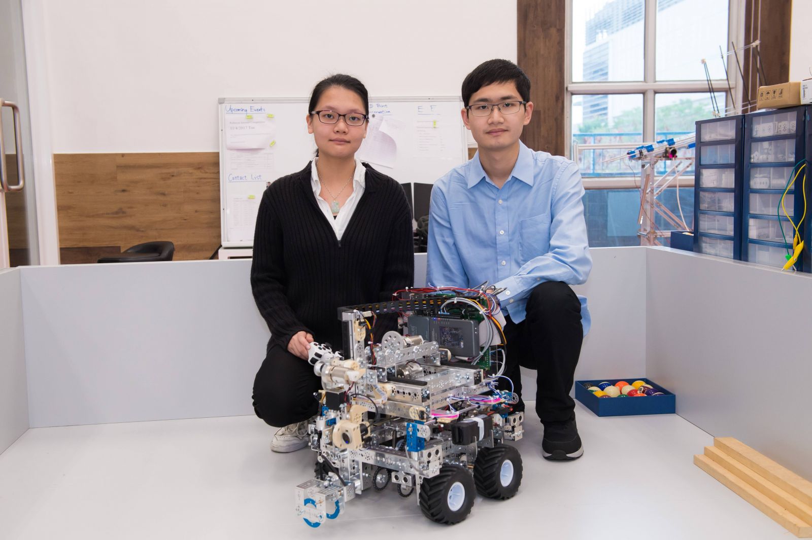 IVE students of the Higher Diploma in Electrical Engineering, LEUNG Ka-ching (left) and NG Pak-yeung (right) join hands to partake in the Mobile Robotics trade of the WorldSkills Hong Kong Competition